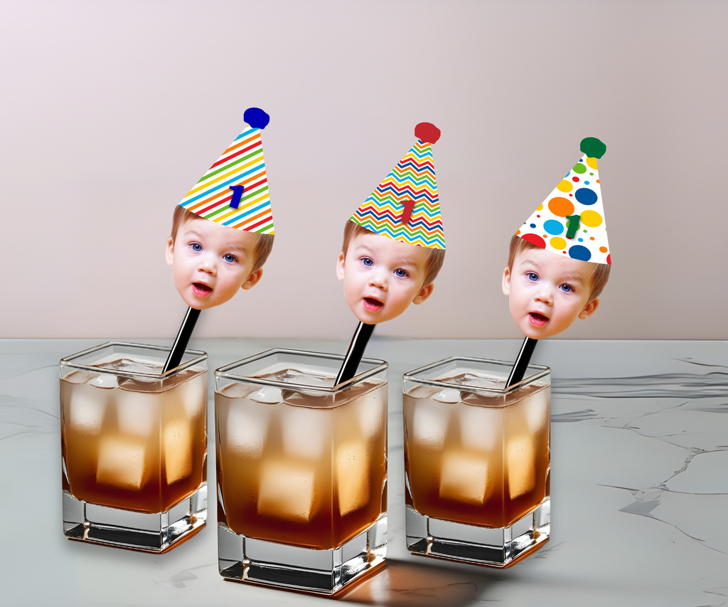 Three glasses with ice cubes and straws, each topped with a colorful birthday hat featuring different face cutouts.