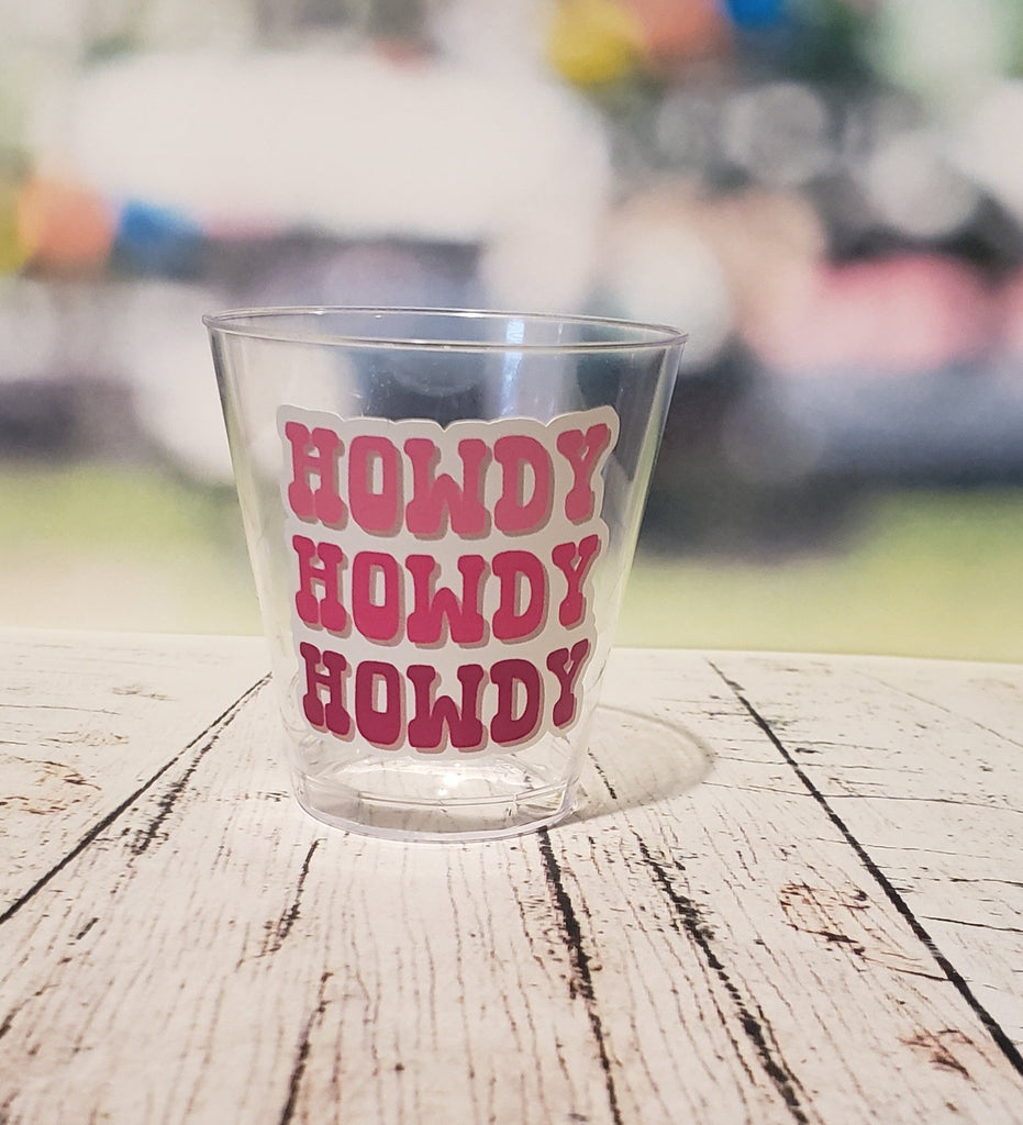 Clear plastic shot glasses with a smooth, cylindrical shape and a small, flat base.
